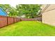 A spacious backyard with lush green grass and a volleyball net for outdoor activities and entertainment at 848 Bucksaw Pl, Longwood, FL 32750