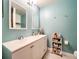 Bright bathroom boasts dual sinks, a vanity, updated lighting, and tiled floors at 848 Bucksaw Pl, Longwood, FL 32750