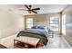 Cozy primary bedroom featuring a ceiling fan, tiled floors, and sun-filled windows at 848 Bucksaw Pl, Longwood, FL 32750