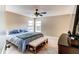 Cozy primary bedroom featuring a ceiling fan, tiled floors, and sun-filled windows at 848 Bucksaw Pl, Longwood, FL 32750