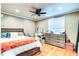 Cozy bedroom with hardwood floors, ceiling fan, and large dresser at 848 Bucksaw Pl, Longwood, FL 32750