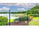 Scenic community view of a serene lake with landscaped surroundings, benches, and a walking path at 848 Bucksaw Pl, Longwood, FL 32750