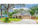 Inviting two-story home with a lush front yard, covered entryway, and attached two-car garage, under a shade tree at 848 Bucksaw Pl, Longwood, FL 32750