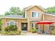 Lovely home with lush landscaping and a charming front porch sitting area with chairs and a table at 848 Bucksaw Pl, Longwood, FL 32750