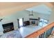 Open-concept living room with vaulted ceilings, fireplace, and sliding door to the patio at 848 Bucksaw Pl, Longwood, FL 32750