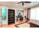 Spacious living area with hardwood floors, a desk, and an opening to another room at 848 Bucksaw Pl, Longwood, FL 32750