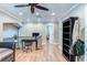 Spacious living area with hardwood floors, a desk, and an opening to another room at 848 Bucksaw Pl, Longwood, FL 32750