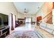 Inviting living room with fireplace, tile flooring, and sliding glass doors to the outdoor patio at 848 Bucksaw Pl, Longwood, FL 32750