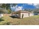 Exterior shot of the backyard with grass, fencing, and rear of the house at 905 Ida St, Wildwood, FL 34785
