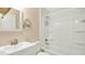 Bathroom featuring a tub with shower and a sink with a large mirror at 905 Ida St, Wildwood, FL 34785