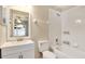 Bathroom with a combination tub and shower, vanity with a large mirror at 905 Ida St, Wildwood, FL 34785