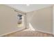 Empty carpeted bedroom features a window for plenty of natural light at 905 Ida St, Wildwood, FL 34785