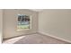 Neutral carpet in bedroom with a large window providing natural light at 905 Ida St, Wildwood, FL 34785