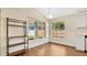 Dining area with natural light, wood floors, and a modern light fixture at 905 Ida St, Wildwood, FL 34785