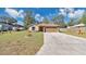 Charming single-story home with a two-car garage and a well-maintained front yard at 905 Ida St, Wildwood, FL 34785