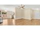 Bright living room with wood floors, neutral walls, with kitchen view at 905 Ida St, Wildwood, FL 34785