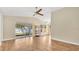 Open concept living room with wood flooring, sliding glass doors, and natural light at 905 Ida St, Wildwood, FL 34785