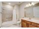 Bathroom features a shower/tub combo with a white shower curtain and a wooden vanity at 9058 Sw 89Th Loop, Ocala, FL 34481