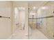 Bathroom featuring a tiled walk-in shower with a glass door, complemented by modern fixtures and neutral tones at 9058 Sw 89Th Loop, Ocala, FL 34481