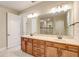Spacious bathroom with dual sinks, wood cabinets, and a large mirror, providing a luxurious feel at 9058 Sw 89Th Loop, Ocala, FL 34481