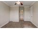 Bedroom features plush carpet, a ceiling fan, and a door to the en-suite bathroom at 9058 Sw 89Th Loop, Ocala, FL 34481