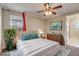 Comfortable bedroom features ceiling fan, window, and neutral decor at 9058 Sw 89Th Loop, Ocala, FL 34481