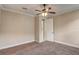Neutral bedroom featuring plush carpet, a ceiling fan with lights, and an en-suite bathroom at 9058 Sw 89Th Loop, Ocala, FL 34481