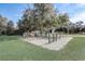 Community park featuring outdoor exercise equipment and mature shade trees at 9058 Sw 89Th Loop, Ocala, FL 34481
