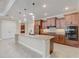 Gourmet kitchen featuring granite countertops, stainless appliances, and custom cabinetry at 9058 Sw 89Th Loop, Ocala, FL 34481