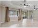 Bright living room with tile floors, recessed lighting, ceiling fans, and access to the outdoor screened area at 9058 Sw 89Th Loop, Ocala, FL 34481