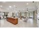 Spacious open floor plan featuring island kitchen and living room with neutral decor and lots of natural light at 9058 Sw 89Th Loop, Ocala, FL 34481