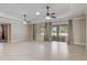 Bright living room with tile floors, recessed lighting, ceiling fans, and access to the outdoor screened area at 9058 Sw 89Th Loop, Ocala, FL 34481