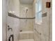 Walk-in shower with mosaic tile accents, a built-in bench, and a window for natural light at 9058 Sw 89Th Loop, Ocala, FL 34481