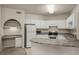 Modern kitchen with white cabinets, granite countertops, and stainless steel appliances at 911 N Orange Ave # 448, Orlando, FL 32801