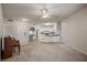 Open living room with kitchen, neutral carpeting, and piano at 911 N Orange Ave # 448, Orlando, FL 32801