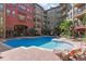 Community pool with brick patio and lounge chairs at 911 N Orange Ave # 448, Orlando, FL 32801