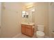 Clean bathroom with wood vanity and toilet at 980 Crestwood Commons Ave, Ocoee, FL 34761