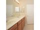 Double vanity bathroom with wood cabinets and a tiled floor at 980 Crestwood Commons Ave, Ocoee, FL 34761