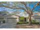 Two-story townhome with attached garage and lush landscaping at 980 Crestwood Commons Ave, Ocoee, FL 34761