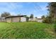 Sprawling backyard with plenty of green space and storage sheds at 9927 6Th Ave, Orlando, FL 32824