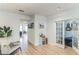 Bright hallway with wood floors, white trim, a sitting area, and view to the living room and bedroom at 1013 Juel Street, Orlando, FL 32814