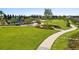 Aerial view of a lush green park with paved walking paths and a playground at 1015 Jack Nicklaus Ct, Kissimmee, FL 34747