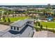 Community aerial view showcases amenities with playground, lush landscapes, and luxury residential houses at 1015 Jack Nicklaus Ct, Kissimmee, FL 34747