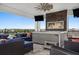Luxurious outdoor balcony features hot tub, fireplace, television, and comfortable lounging furniture at 1015 Jack Nicklaus Ct, Kissimmee, FL 34747