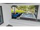 Covered balcony featuring hot tub, outdoor seating, and relaxing neighborhood views at 1015 Jack Nicklaus Ct, Kissimmee, FL 34747