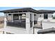 Balcony featuring a hot tub, stone fireplace, and a comfortable seating area at 1015 Jack Nicklaus Ct, Kissimmee, FL 34747