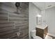 Modern bathroom with a gray tile shower and a sleek glass door at 1015 Jack Nicklaus Ct, Kissimmee, FL 34747