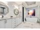 Luxurious bathroom featuring white cabinets, double sinks, modern fixtures, and a standalone tub at 1015 Jack Nicklaus Ct, Kissimmee, FL 34747