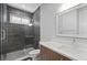 Modern bathroom with a tiled shower, white vanity, and a large mirror at 1015 Jack Nicklaus Ct, Kissimmee, FL 34747