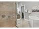 Contemporary bathroom featuring a glass shower, sleek fixtures, and neutral tiling at 1015 Jack Nicklaus Ct, Kissimmee, FL 34747